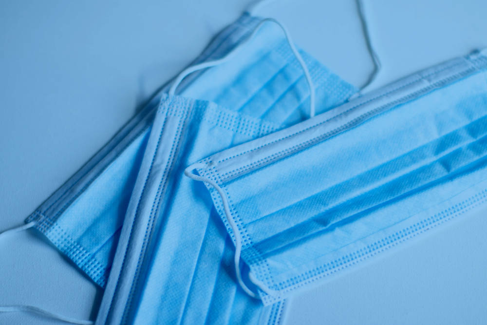 A white table with surgical masks laying on top